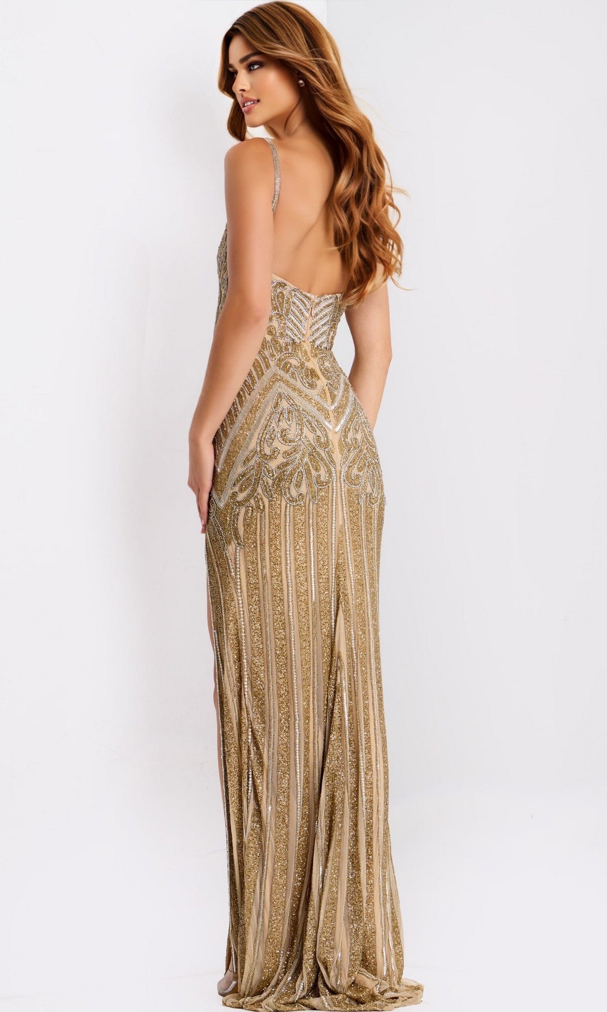 A woman faces away from the camera, wearing the Jovani 49810 long prom dressโa gold, beaded, floor-length sheath gown with an open backโset against a plain white background.